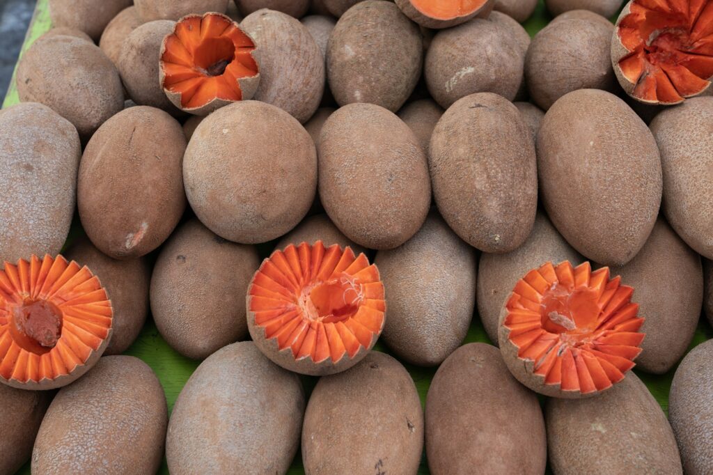 Mamey Sapota fruit whole and sliced on display at a market in Oaxaca, Mexico